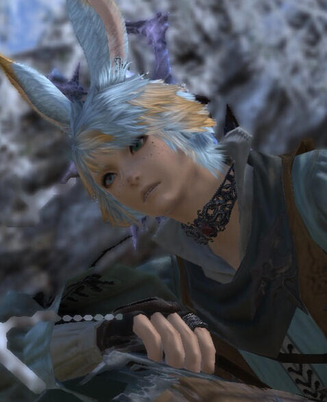 A youth with fluffy bunny ears and a pensive expression on his face.